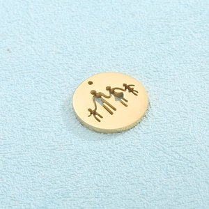 Macro detail of golden circular pendant featuring family silhouette cutout on blue background