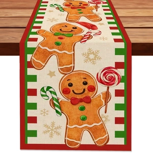 Detail of Christmas gingerbread man table runner with linen texture on wood table