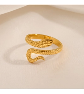 Macro detail of golden snake ring showing intricate scale texture and open design