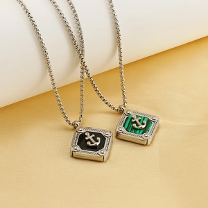 Detailed close-up of retro titanium steel anchor pendants with black and green accents