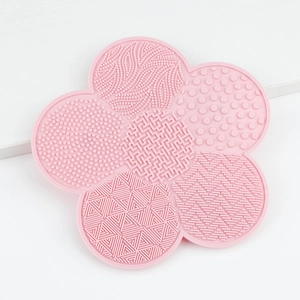 Pink petal-shaped silicone makeup brush cleaning mat with various deep-clean textures