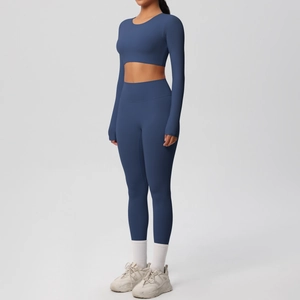 Detail view of the side profile of navy blue long sleeve yoga top and high waist leggings