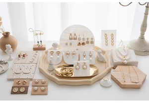 Cloud pattern acrylic jewelry display stands showcasing gold earrings and necklaces