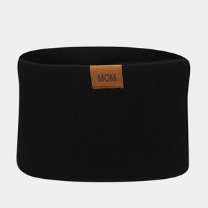 Detailed view of black ribbed knit headband with brown leather MOM label for winter wear