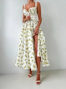 Detail of floral sundress featuring lemon print, ruched bust, and high side leg slit