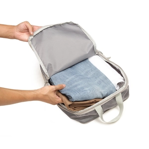 Detail of grey compression packing cube with durable mesh and handle for travel