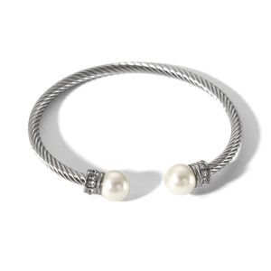Detailed macro of silver twisted cable bracelet with pearls and crystal accents