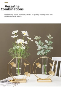Close-up of geometric Morandi vases with metal bird decor and glass test tubes for hydroponics