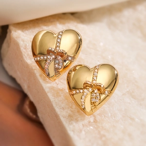 Elegant 18K gold plated heart earrings with sparkling zircon bow accents on stone base