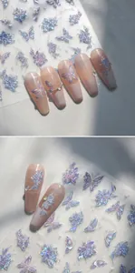 Macro detail of laser holographic butterfly and flower nail art stickers on pink nails