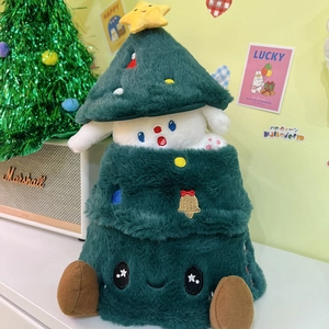 Detail of plush animal toy in Christmas tree outfit on sofa with festive decorations