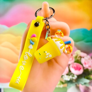 Detail of yellow creative ice cream cup keychain with silicone Love wrist strap
