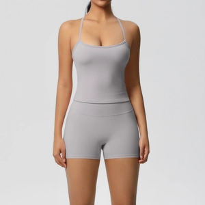 Close-up of grey high-stretch yoga set with spaghetti strap top and high-waist biker shorts