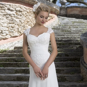 Elegant white off-shoulder lace mermaid wedding dress with a long train and sequin embroidery