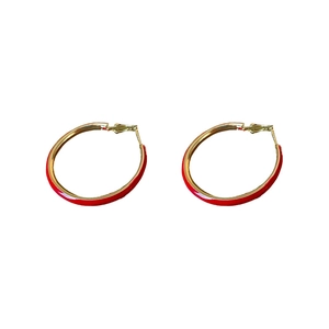 Retro red and gold enamel hoop earrings with silver needles on a white background