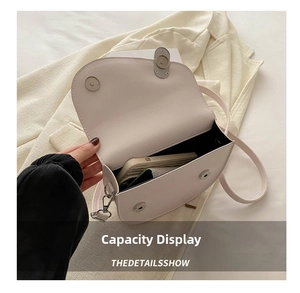 Interior view showing the capacity of a white saddle bag with a smartphone inside