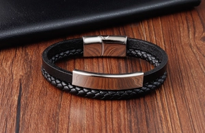 Macro detail of men's black braided leather bracelet with stainless steel magnetic clasp