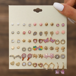 Detail of 30-pair earring set featuring gold-tone heart, flower, and butterfly designs