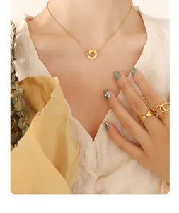 Detail of 18K gold plated necklace with Roman numeral rings and crystal accents