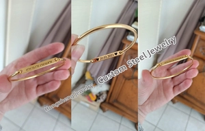 Detailed close-up of custom engraved gold bangle with unique coordinates and date