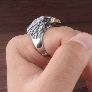 Detailed view of vintage eagle head ring with golden beak and red gemstone eyes