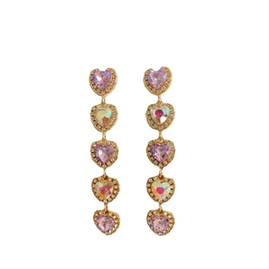 Elegant gold drop earrings featuring five heart-shaped purple and iridescent crystals