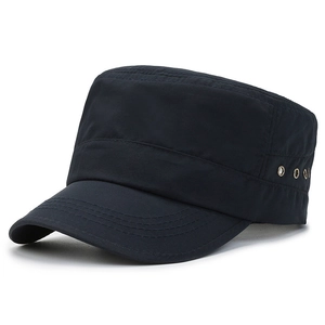 Close-up of black flat top military cap with reinforced stitching and metal air vents