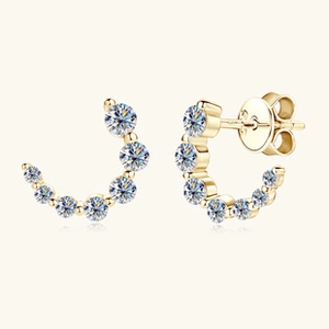 Detailed macro shot of gold S925 sterling silver earrings with round moissanite clusters
