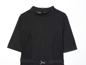Detail of black short sleeve dress featuring a high neck and adjustable silver buckled belt