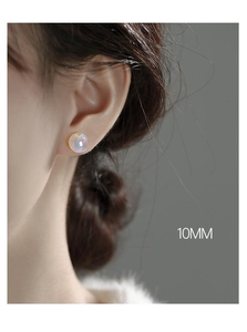 Detail shot of 10mm iridescent mermaid pearl stud earrings worn on an earlobe