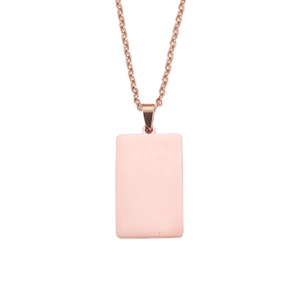 Macro detail of polished rose gold rectangular pendant on a fine necklace chain