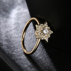 Rotating 18K gold plated copper ring with zircon crown and star design on black leather