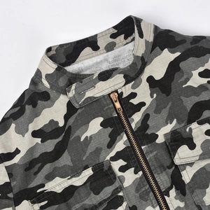 Macro shot of camo jacket stand-up collar with metallic zipper and velcro closure detail