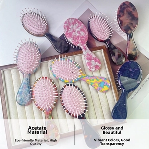 Close-up of portable acetate hair brushes in marble and tortoiseshell patterns