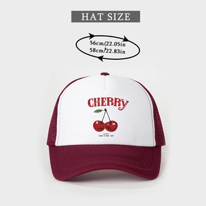 Detail view of red cherry print and happy text on white panel of mesh trucker hat