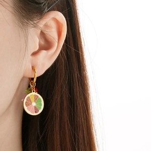 Detailed close-up of rainbow lemon slice earring in polished stainless steel and enamel