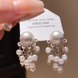 Detailed close-up of 925 silver needle floral pearl drop earrings with sparkling crystals