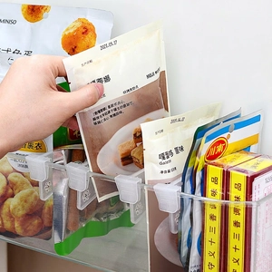 Adjustable refrigerator shelf dividers for organized snack storage in transparent bins
