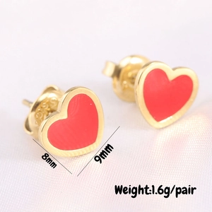 Detail of red heart earrings with gold trim and 925 silver studs, size 8mm x 9mm