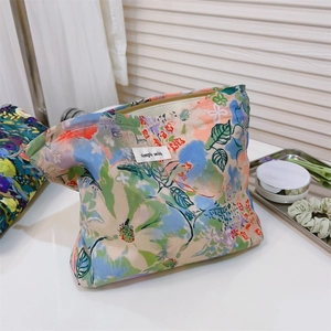 Detailed view of floral cotton makeup bag with zipper and simple wish woven label