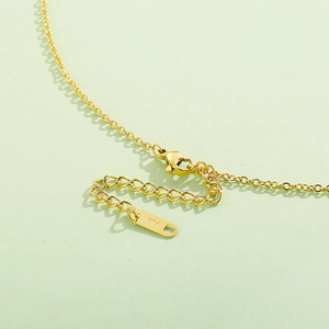 Detailed macro view of 14K gold plated necklace clasp and extender with K14 engraving