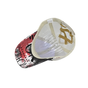 Detail of ponytail baseball cap showing criss-cross elastic bands and graffiti brim design