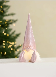 Close-up of a pink metallic LED Christmas gnome with a fluffy white beard for holiday decor