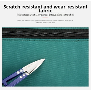 Close-up of green Oxford fabric waist bag showing scratch-resistant material and zipper