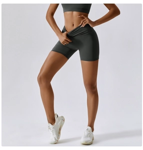 Close-up of high-waisted dark grey yoga shorts showcasing elastic fabric and slim fit