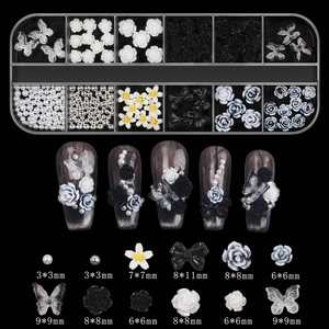 Detail of 12-slot nail art set with aurora bows pearls and studs on black background