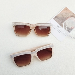 Close-up of luxury oversized square sunglasses with sparkling rhinestone inlay on frame