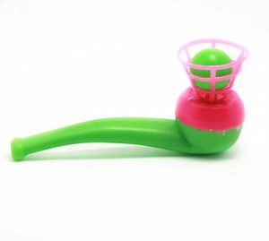 Close-up of a retro plastic floating pipe ball toy with green stem and red base