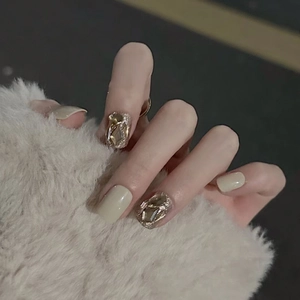 Close-up of brown gradient press-on nails with champagne crystal and rhinestone detail