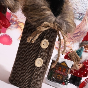 Detail of Christmas wine bottle cover with brown herringbone fabric and fur collar